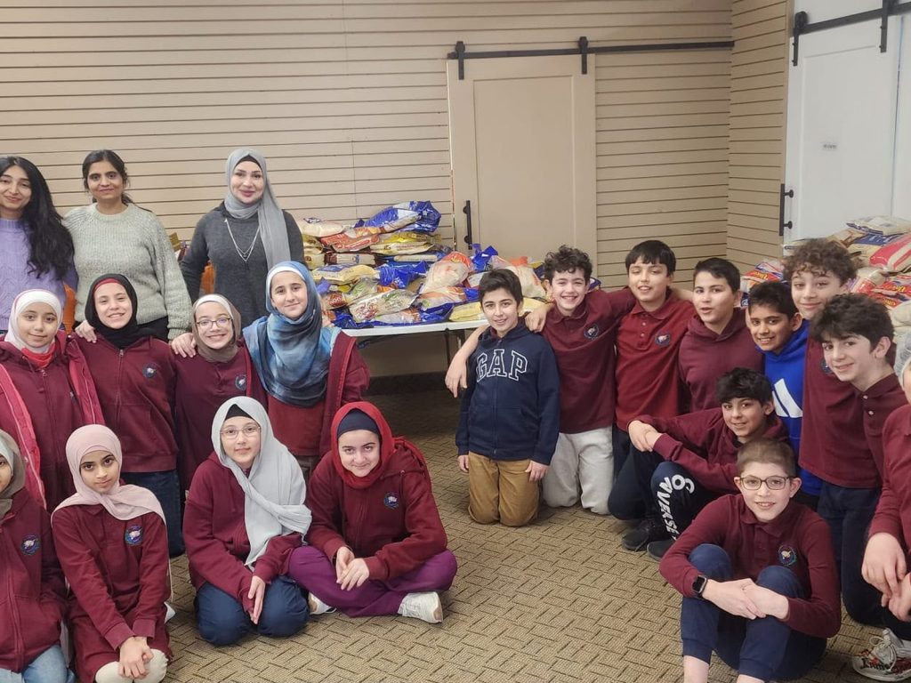 Young volunteers with Halal Food Bank Canada after a food packing session